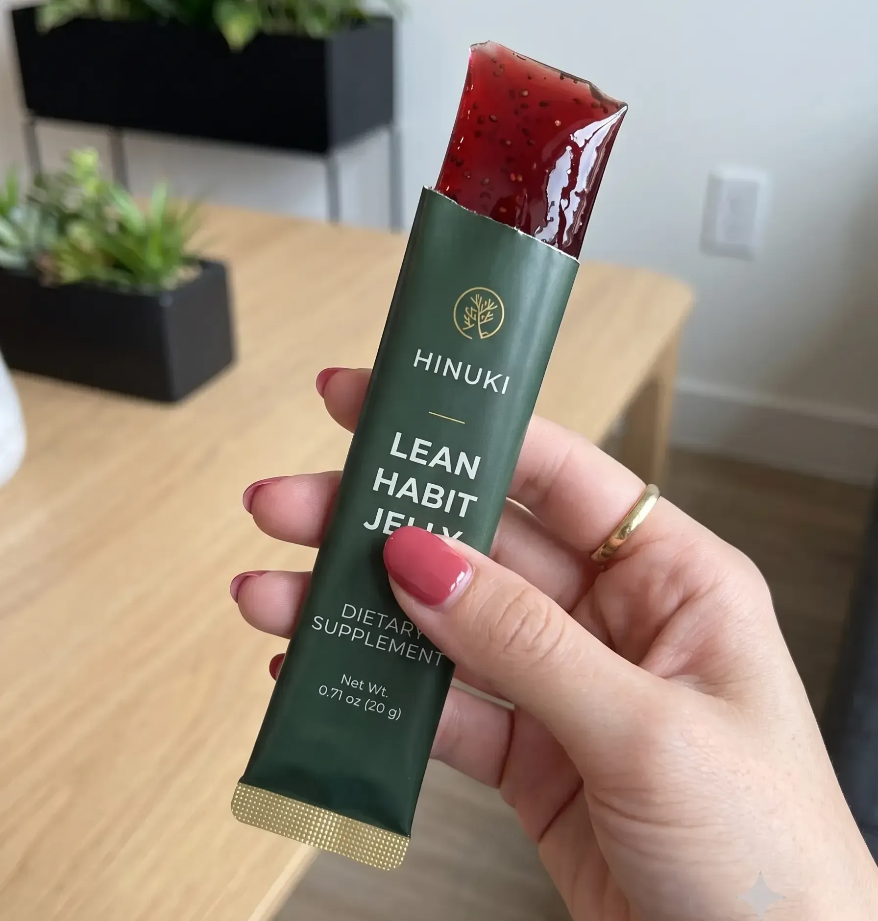 Tearing open a Hinuki Cutting Jelly stick — ready-to-eat pomegranate sachet, no water needed